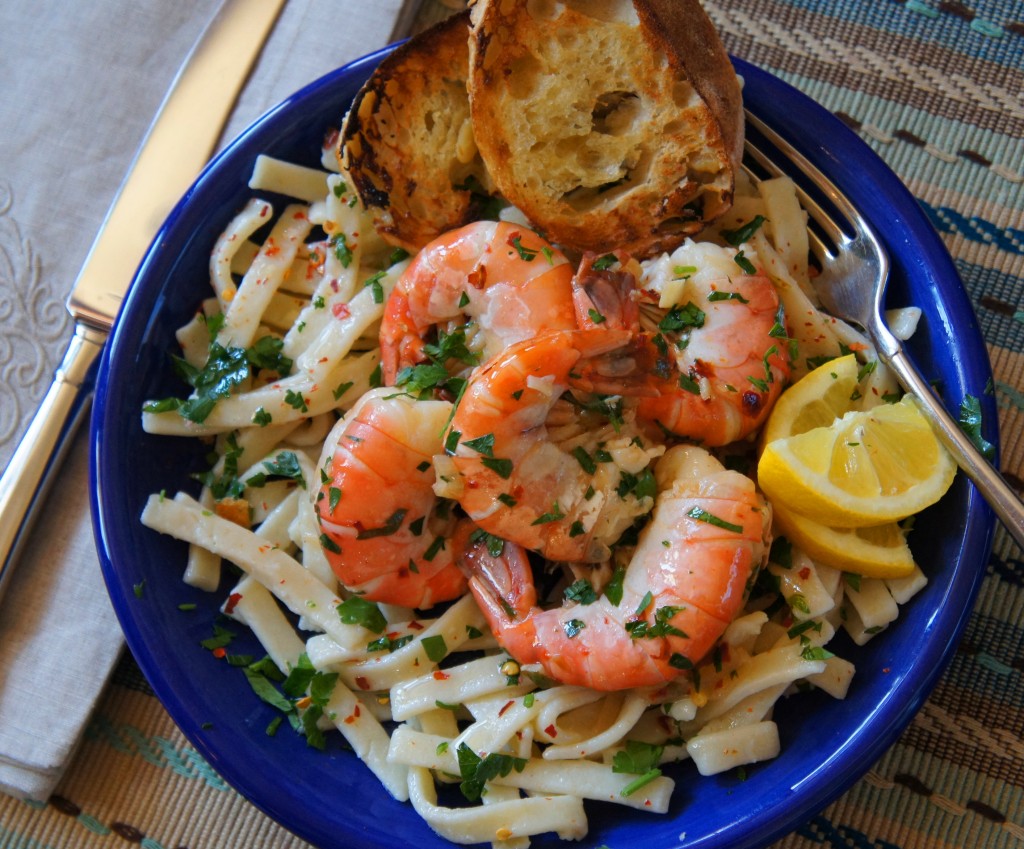 Grandma's frozen pasta server with shrimp, herbs, lemon and herbs in a blue bowl